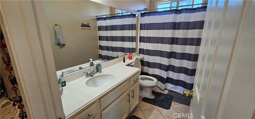 1650 Ravenswood Road Beaumont, CA 92223 - Photo 26 of 42 a bathroom with a sink toilet and shower