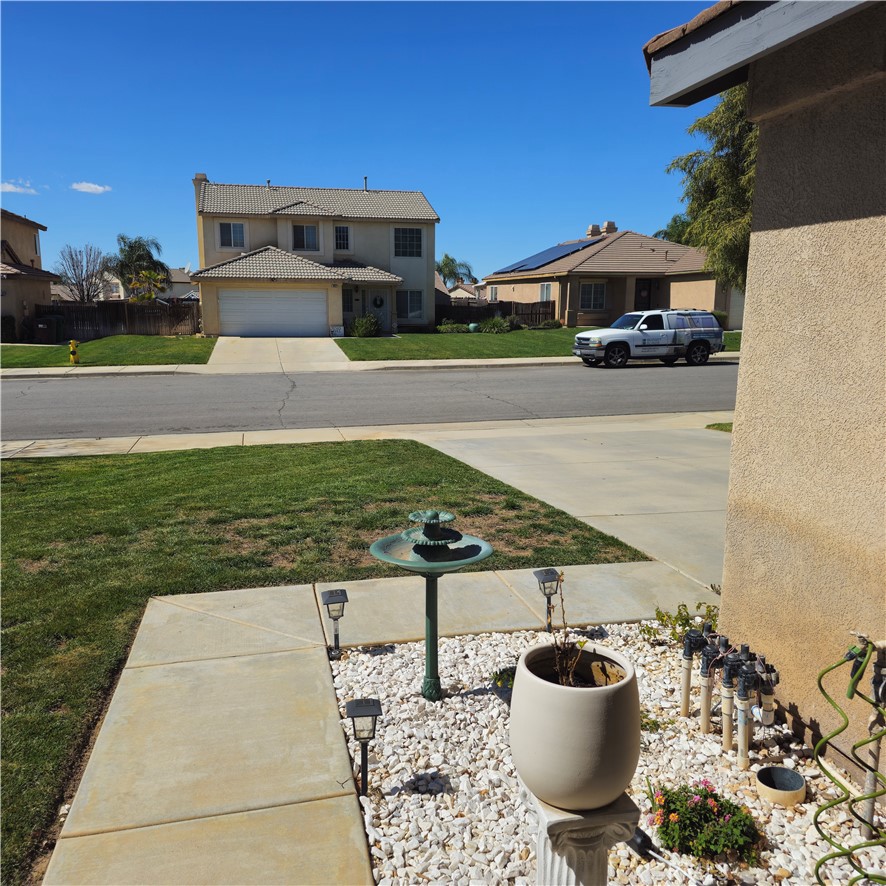 1650 Ravenswood Road Beaumont, CA 92223 - Photo 3 of 42 a view of a patio with lawn chairs under an umbrella