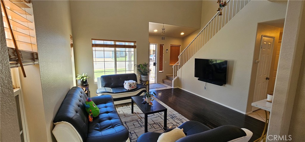 1650 Ravenswood Road Beaumont, CA 92223 - Photo 7 of 42 a living room with furniture and a flat screen tv