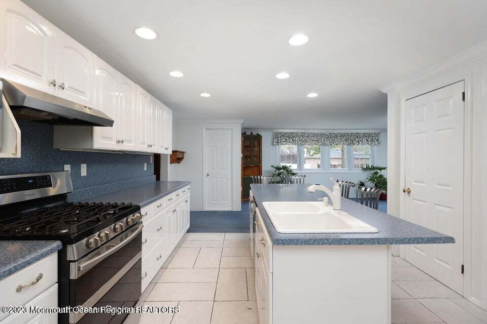 219 Elmwood Road Oakhurst, NJ 07755 - Photo 3 of 4 a kitchen with a sink stainless steel appliances and cabinets