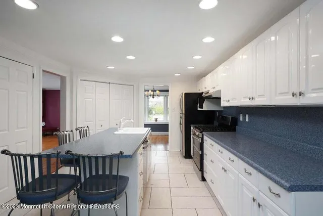 a kitchen with stainless steel appliances kitchen island granite countertop a sink and cabinets