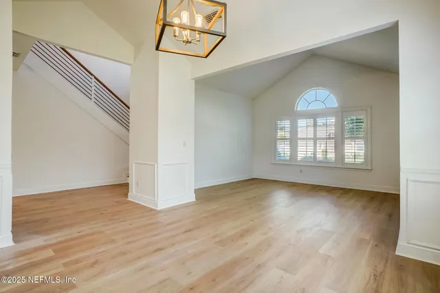 a view of empty room with wooden floor and fireplace