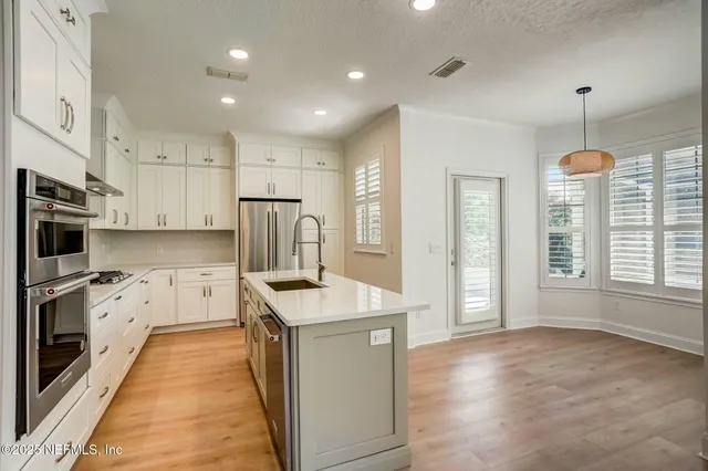 a spacious bathroom with a shower and a sink