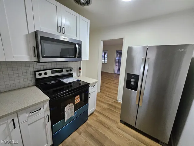 a kitchen with a stove microwave and refrigerator