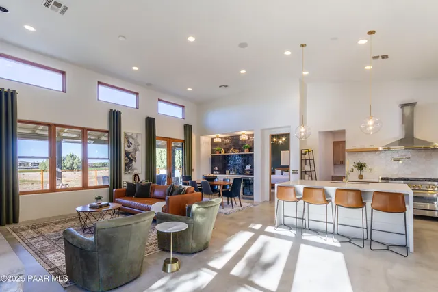 a living room with fireplace furniture and a large window