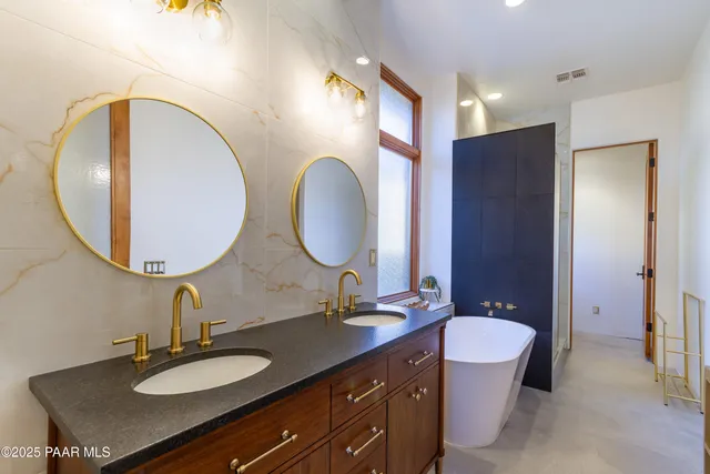 a bathroom with 2 sink and a mirror