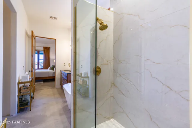 a en suite bathroom with a glass shower door and a bathroom