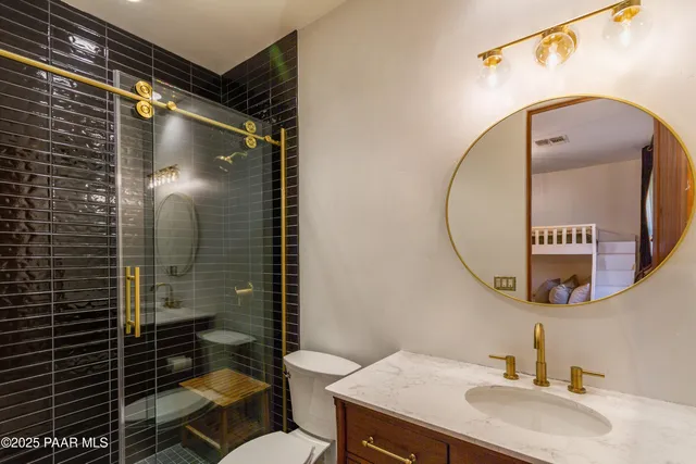a bathroom with a sink mirror toilet and shower
