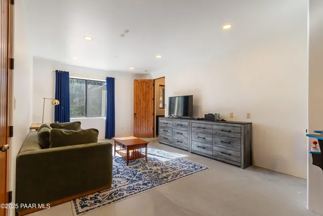 a living room with furniture and flat screen tv