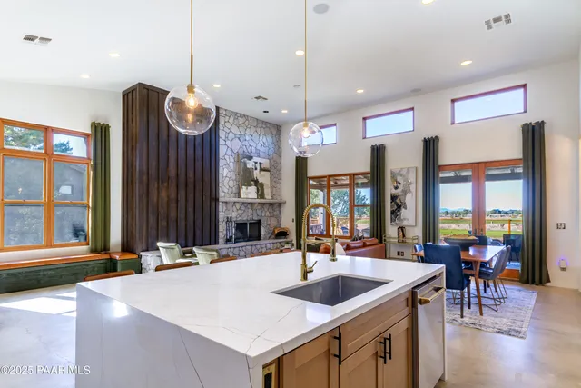 a kitchen with a sink a counter and chairs
