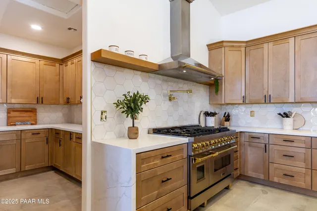 a kitchen with stainless steel appliances granite countertop a sink and cabinets