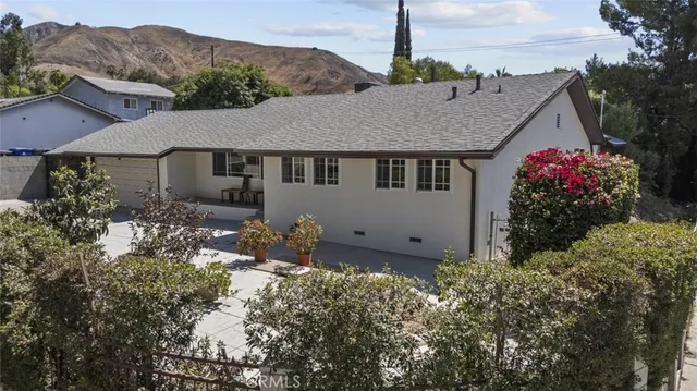 a view of a house with a yard and garden