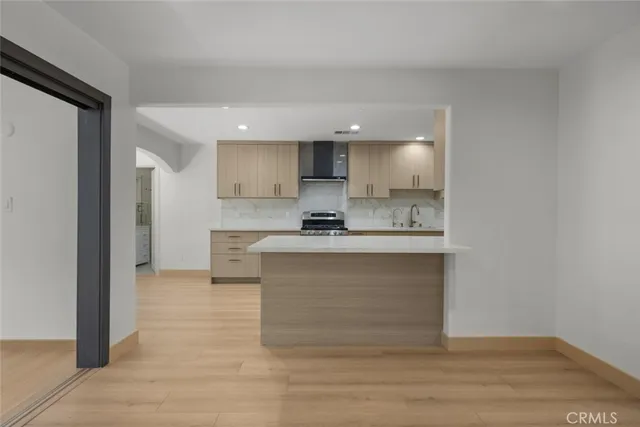 a view of kitchen with granite countertop cabinets and refrigerator