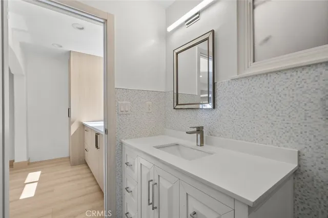 a bathroom with a sink a vanity and a mirror