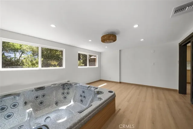 a view of a bedroom with window and wooden floor