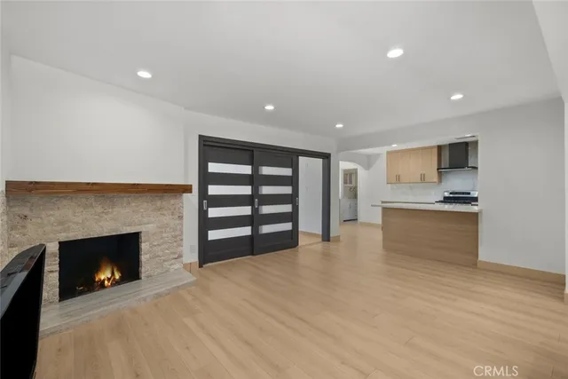a view of kitchen with kitchen island a sink and a fireplace