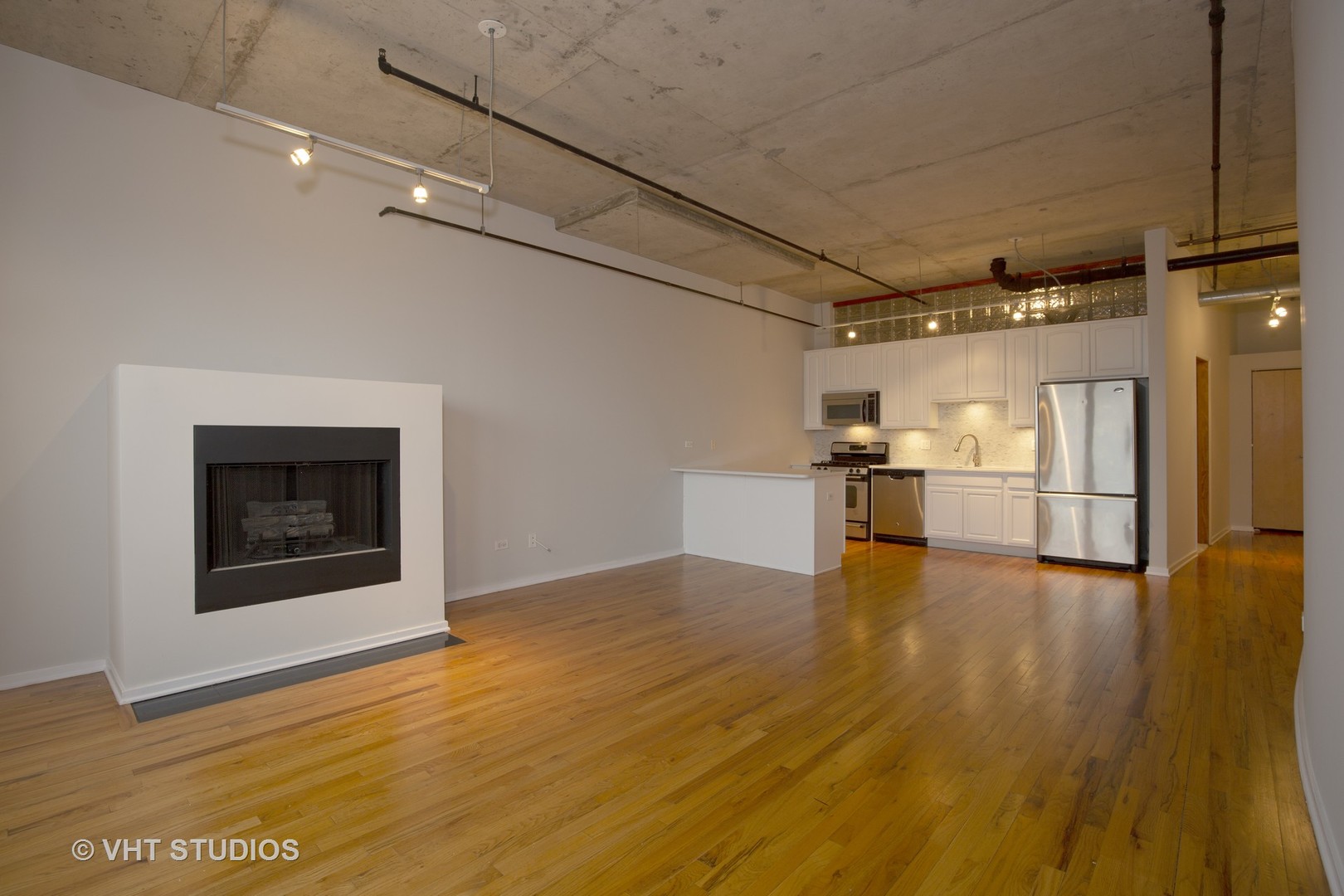 6 South Laflin Street, Unit 807S Chicago, IL 60607 - Photo 18 of 18 a view of empty room with wooden floor and fireplace