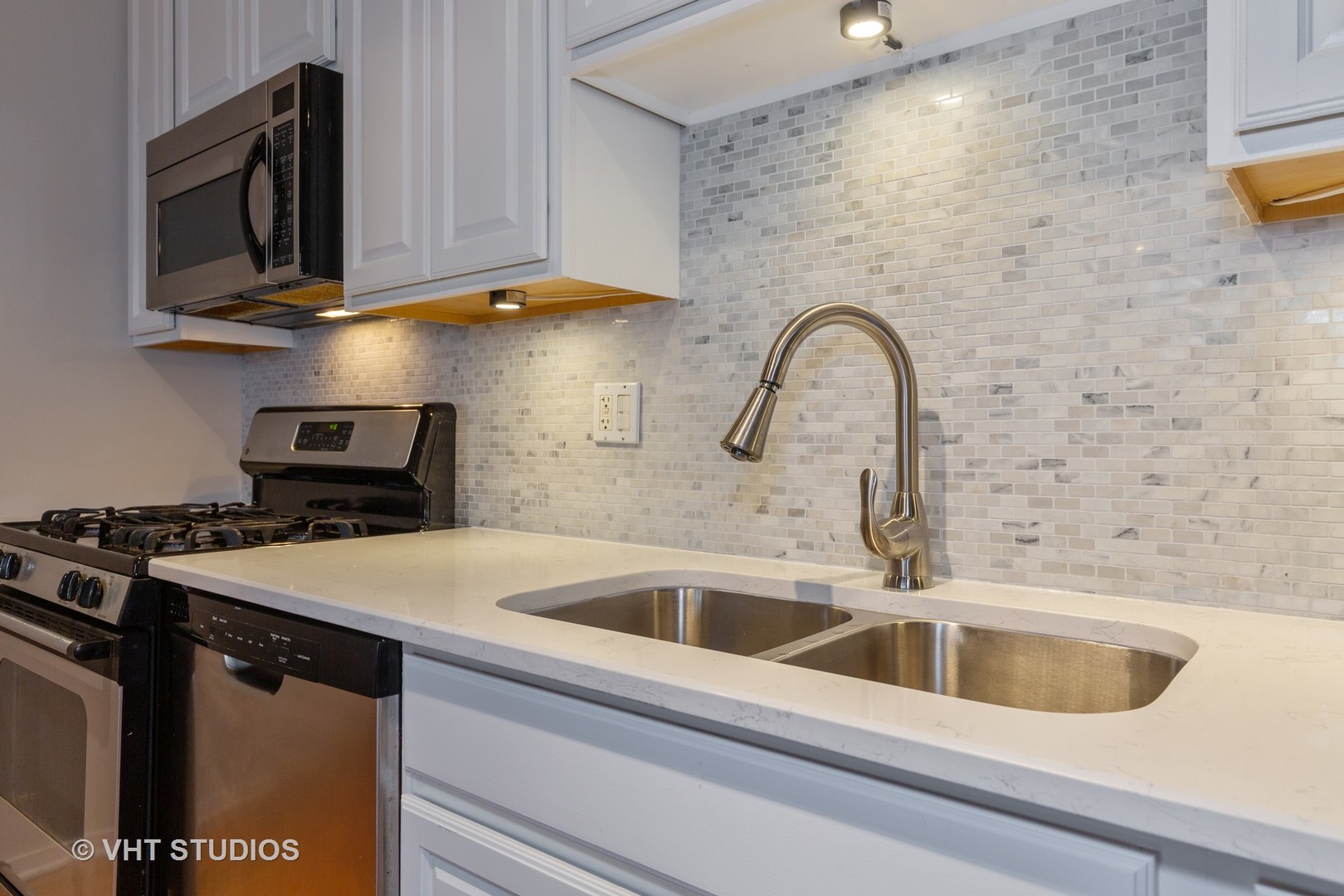 6 South Laflin Street, Unit 807S Chicago, IL 60607 - Photo 4 of 18 a close view of a sink and a microwave in a kitchen