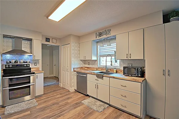 a kitchen with a sink stove and refrigerator