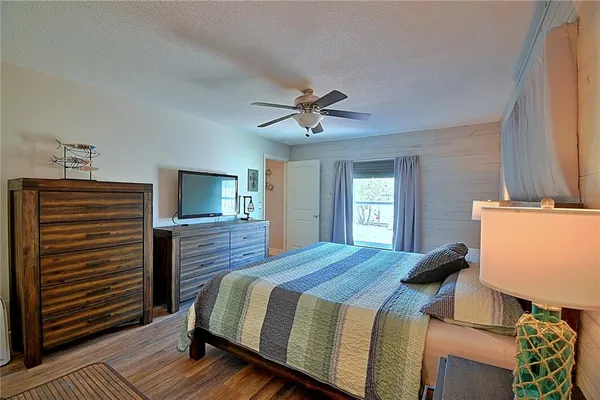 a bedroom with a bed and a ceiling fan
