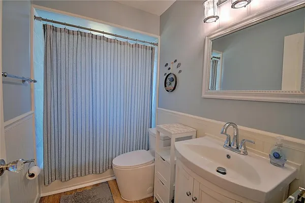 a white toilet sitting next to a bathroom sink