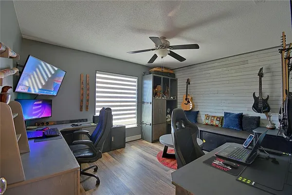 a view of a workspace with furniture and a window