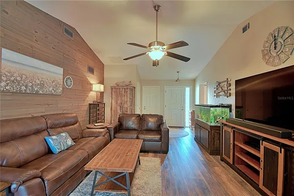 a living room with furniture and a flat screen tv