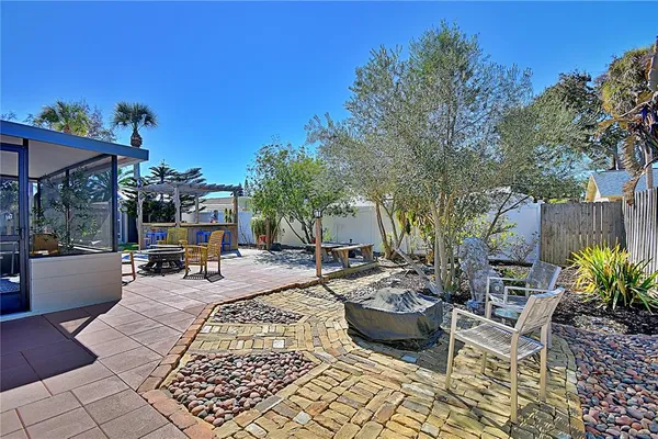 a view of a backyard with sitting area
