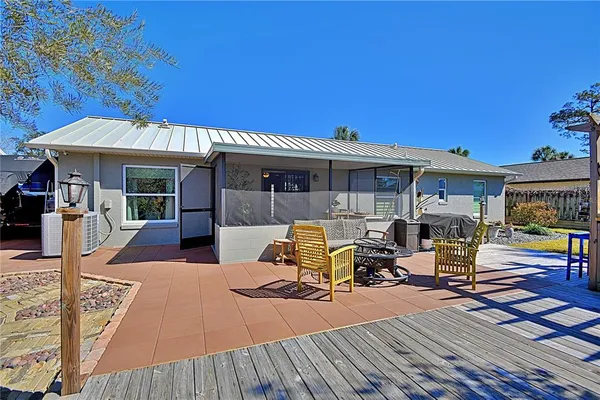 a view of a patio with dining table and chairs with wooden floor and fence