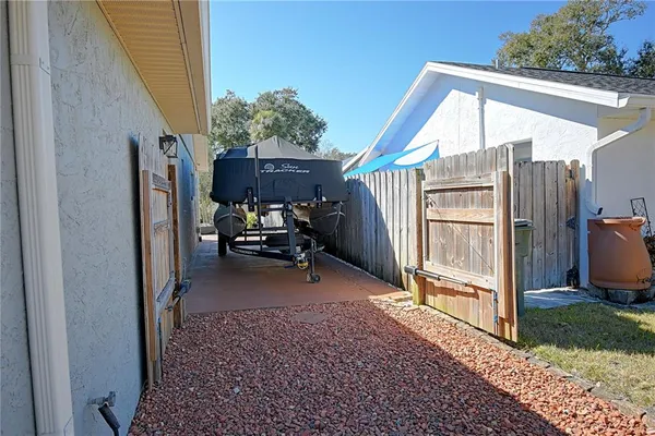 a view of a porch with furniture and a yard