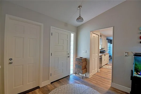 a view of a hallway with wooden floor and closet area