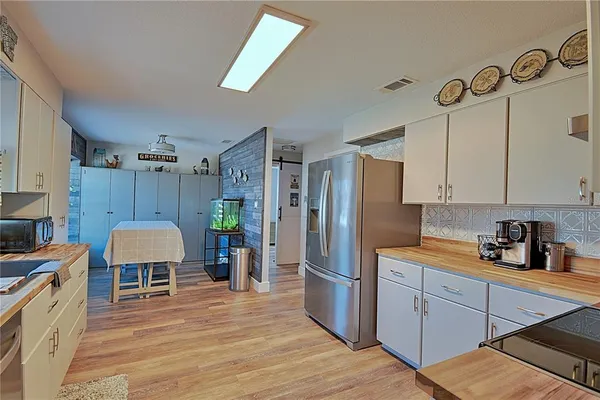 a kitchen with a refrigerator a stove and cabinets