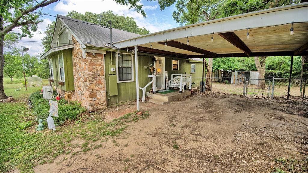 140 Elm Road Nocona, TX 76255 - Photo 20 of 26 a front view of a house with garden