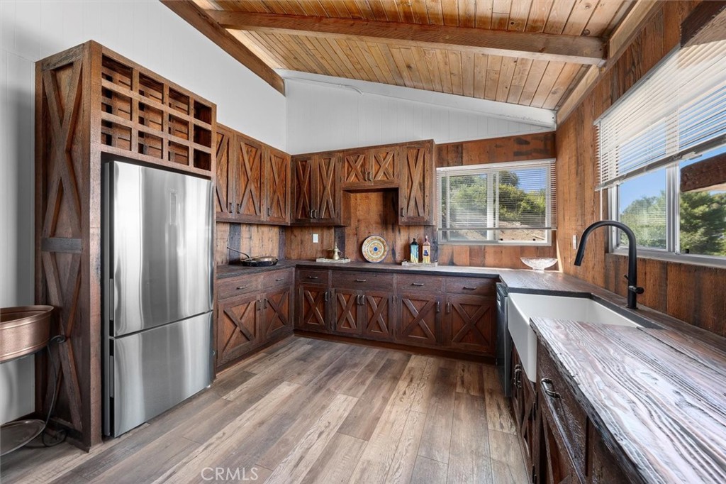 4 Poppy Trail Rolling Hills, CA 90274 - Photo 8 of 13 a kitchen with granite countertop a refrigerator a sink dishwasher a stove and white countertops with wooden floor