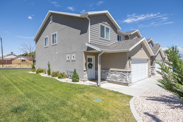 4991 South 475 West Washington Terrace, UT 84405 - Photo 4 of 31 Gray stucco and siding exterior with white trim