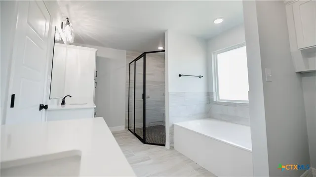 a bathroom with a bathtub and a shower