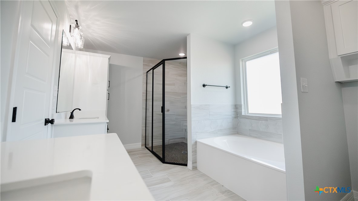 1321 Red Rock Road Lorena, TX 76655 - Photo 13 of 25 a bathroom with a bathtub and a shower