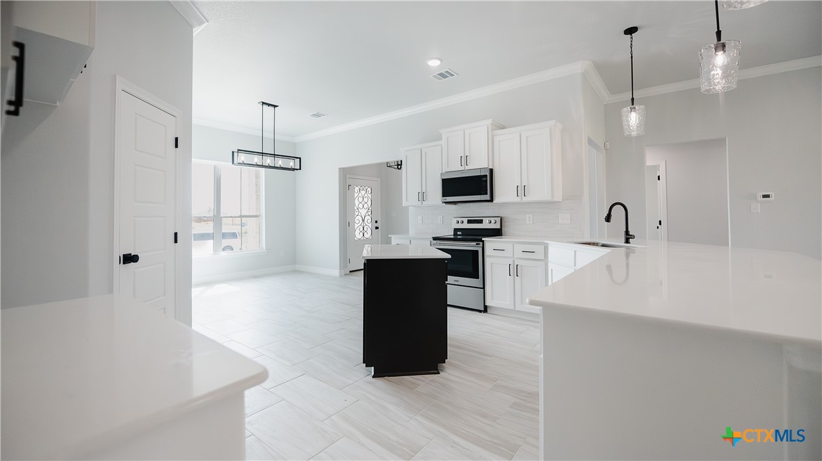 1321 Red Rock Road Lorena, TX 76655 - Photo 15 of 25 a large white kitchen with a refrigerator a sink and a stove