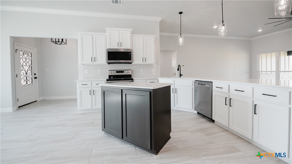 1321 Red Rock Road Lorena, TX 76655 - Photo 16 of 25 a kitchen with stainless steel appliances a stove a sink and a refrigerator