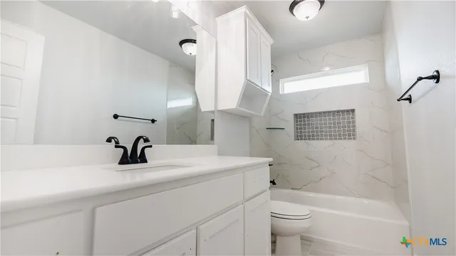 a bathroom with a sink a toilet and a bathtub