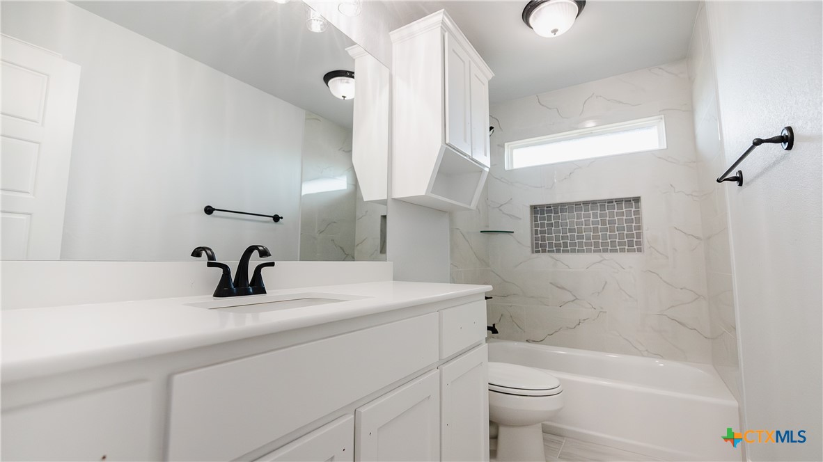 1321 Red Rock Road Lorena, TX 76655 - Photo 20 of 25 a bathroom with a sink a toilet and a bathtub