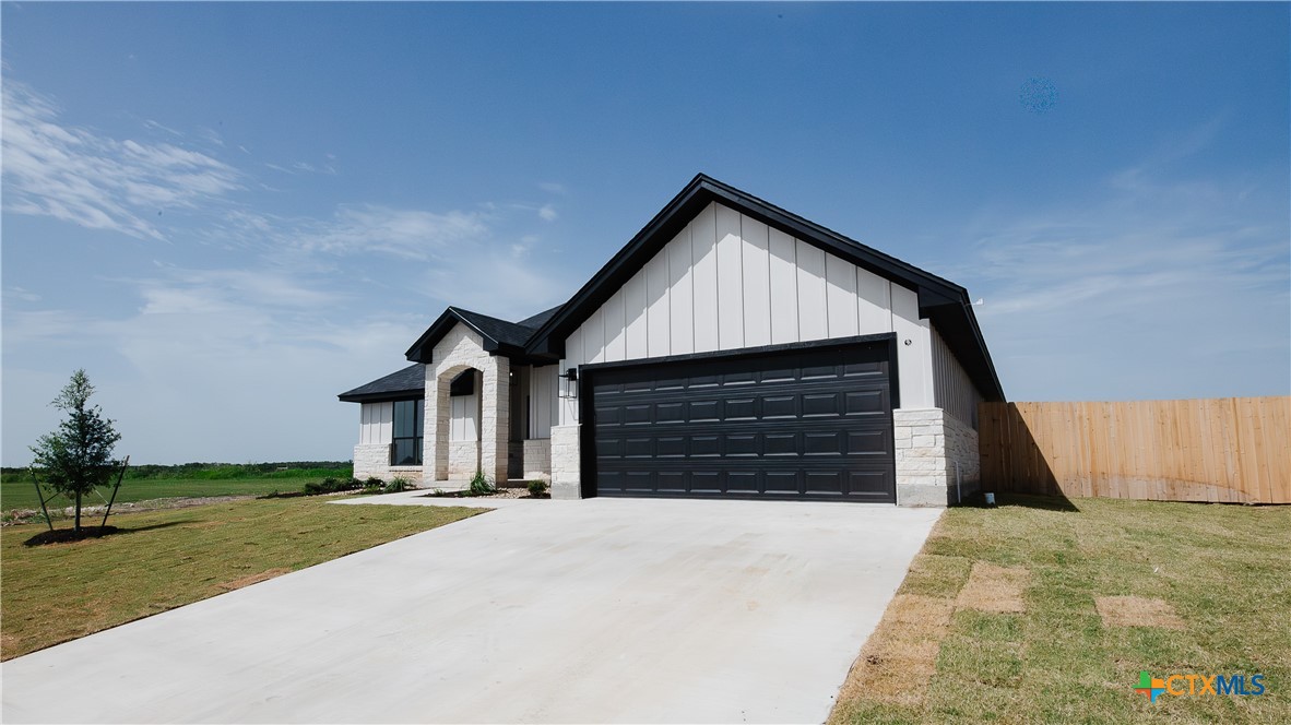 1321 Red Rock Road Lorena, TX 76655 - Photo 2 of 25 a front view of a house with a yard and garage