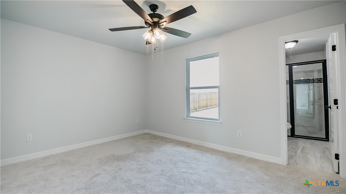 1321 Red Rock Road Lorena, TX 76655 - Photo 21 of 25 an empty room with a window and a fan