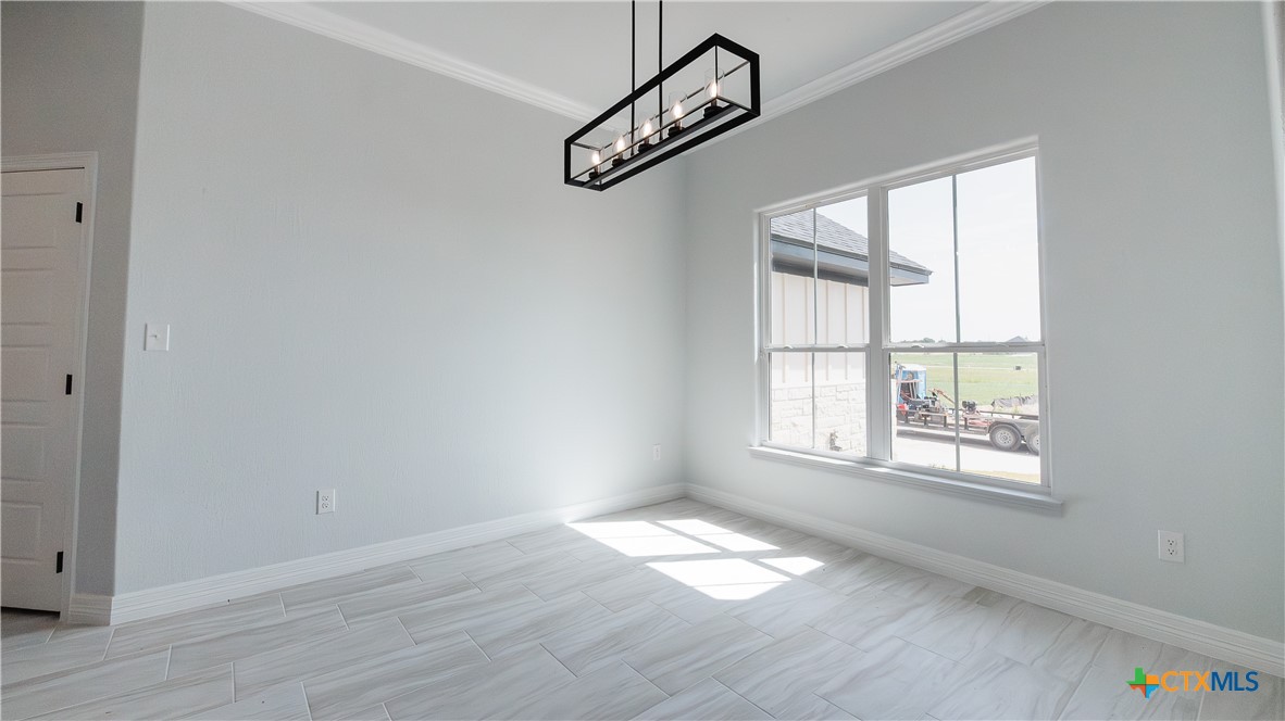 1321 Red Rock Road Lorena, TX 76655 - Photo 4 of 25 a view of an empty room with wooden floor and a window