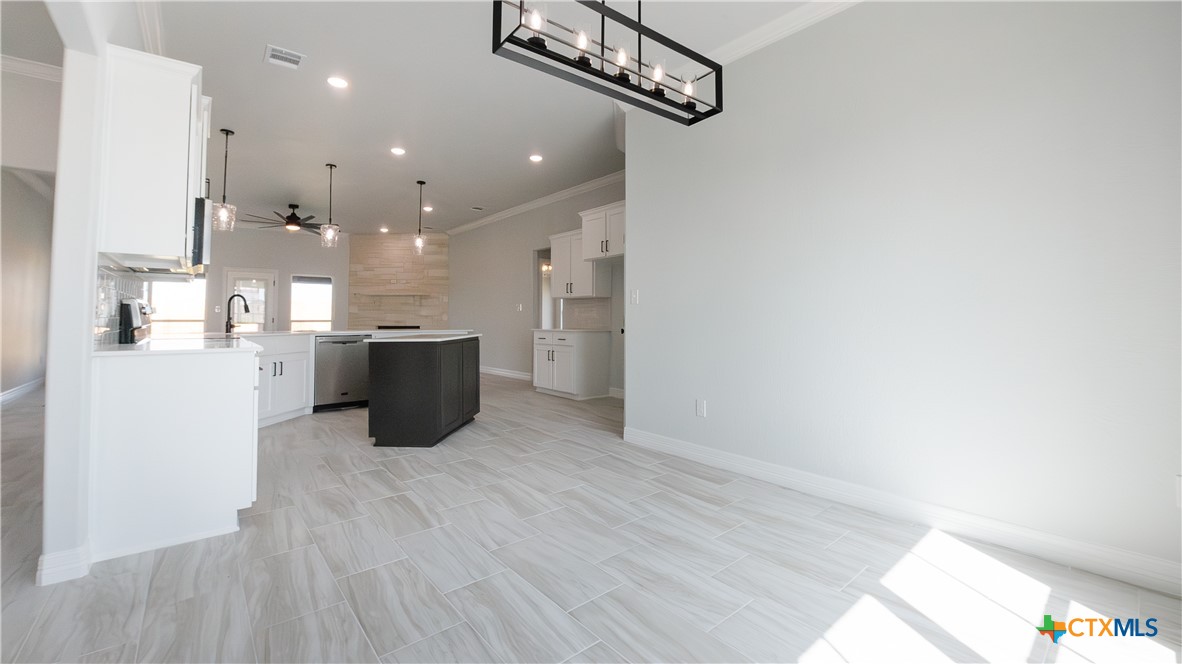 1321 Red Rock Road Lorena, TX 76655 - Photo 5 of 25 a open kitchen with a refrigerator and a microwave