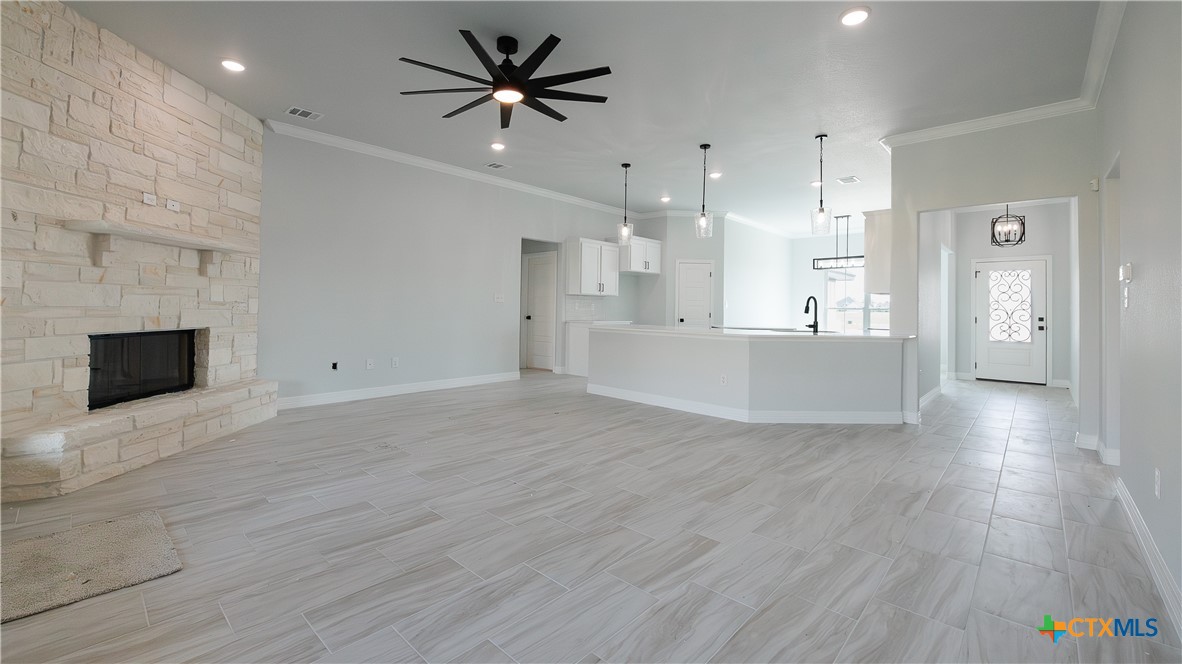 1321 Red Rock Road Lorena, TX 76655 - Photo 8 of 25 a view of a big room with wooden floor and a kitchen