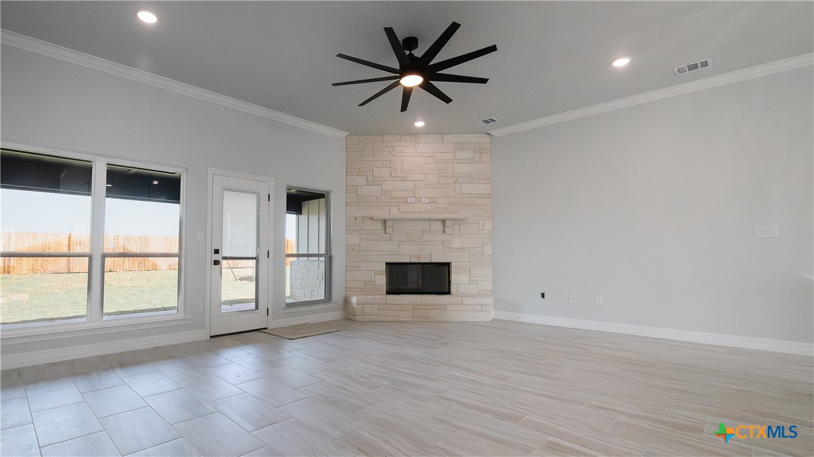 1321 Red Rock Road Lorena, TX 76655 - Photo 9 of 25 an empty room with windows and ceiling fan