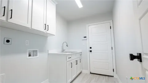 a spacious bathroom with a sink and a mirror