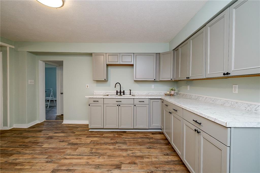 517 North 4th Street Apollo, PA 15613 - Photo 5 of 27 a kitchen with granite countertop a sink stove and cabinets