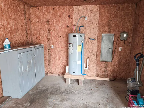 a kitchen with granite countertop a sink dishwasher stove and cabinets